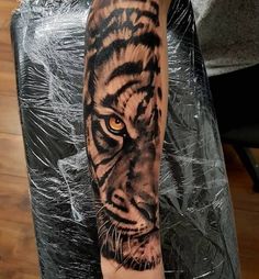 a man with a tiger tattoo on his arm