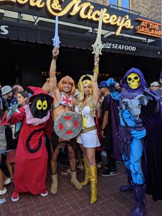 two women in costumes are posing for a photo with some people dressed as cartoon characters