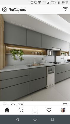 an image of a kitchen with grey cabinets and white counter tops on the phone screen