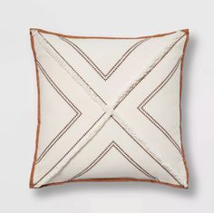 a white pillow with brown trim on it