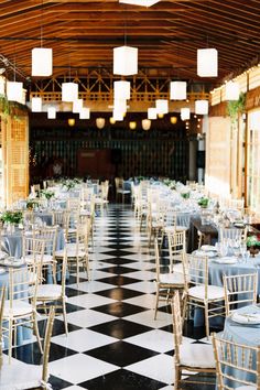 an indoor dining area with tables and chairs set up for formal function or wedding reception