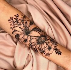 a woman's arm with flowers on it