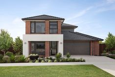 a two story brick house with landscaping in front