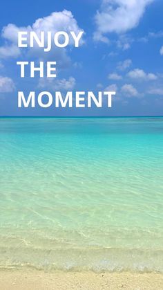 the words enjoy the moment written in white on a blue sky and ocean background with clear water