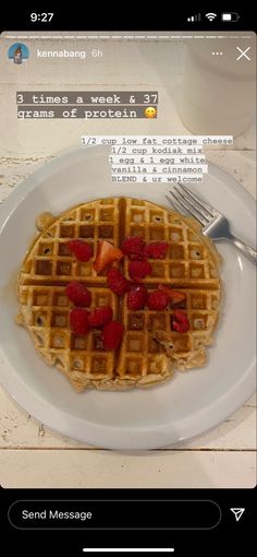 a white plate topped with waffles and strawberries