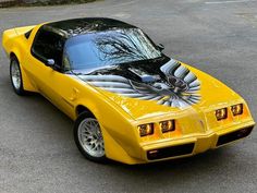 a yellow sports car parked in a parking lot