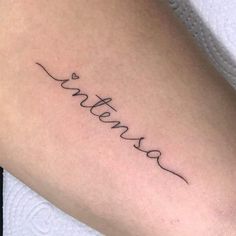 a woman's arm with the word love written in cursive writing on it