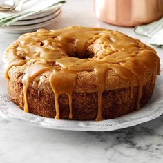 a bundt cake with caramel drizzled on top sitting on a plate