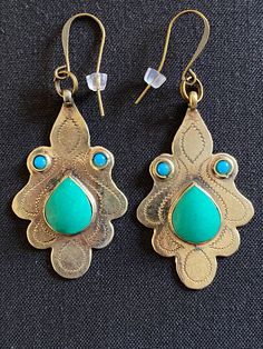 Chrysoprase and Turquoise bronze tribal ethnic chandelier belly dance bohemian earrings.   Beautiful and unique light bronze chandelier wire earrings with a cabochon chrysoprase tear shaped gemstone surrounded by two small round turquoise gemstones.  These earrings measure 2.5" in total length including the wire and 1" in width.  They are attractive and easy to wear.  They add lots of style and character to your attire and are sure to bring you lots of compliments. Nickel Free Brass Chandelier Earrings For Festivals, Nickel-free Brass Chandelier Earrings For Festivals, Brass Chandelier Earrings For Festivals, Wire Wrapped Chandelier Earrings For Festivals, Brass Chandelier Drop Earrings For Festival, Bohemian Bronze Pierced Chandelier Earrings, Bohemian Bronze Chandelier Earrings For Pierced Ears, Brass Dangle Chandelier Earrings For Festivals, Bronze Dangle Earrings For Festivals