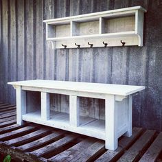 a white bench sitting on top of a wooden pallet