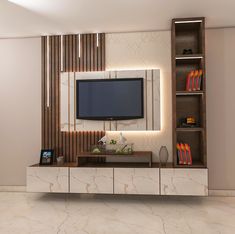 an entertainment center with a flat screen tv mounted on the wall and bookshelves