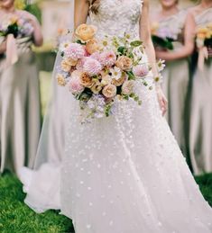 a bride and her bridals holding their bouquets in front of the camera