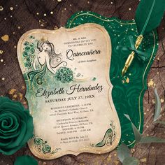 an ornate green and gold wedding card with a rose on the table next to it