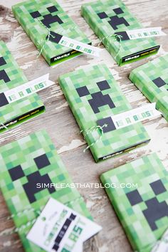 some green and black squares are laid out on a table with tags attached to them