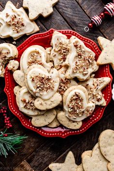 a red plate topped with cookies covered in white frosting