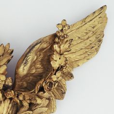 a golden bird statue sitting on top of a table