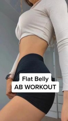 the woman is showing off her flat belly