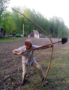 an old man is holding a bow and arrow