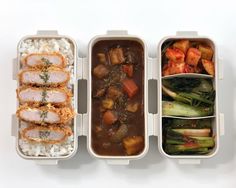 three plastic containers filled with food on top of a white table next to each other