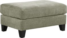 the foot stool is upholstered and ready to be used as a storage bench