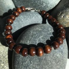 Unique mocha wood prayer beads bracelet with pewter accents. Custom length available ensuring a perfect fit.  Please specify your size in the comments of your order along with elastic or toggle closure. IF NO SIZE IS SELECTED, DEFAULT WILL BE ELASTIC AND MEDIUM (7.5 inches Petite (6.5) Inches Small (7.0) Inches Medium (7.5) Inches Large (8.0) Inches Custom (pls specify) Inches We are willing to work with you on a custom design as well so you have that original one of a kind piece! All of our items are shipped in a velvet pouch so you can safely store your piece for years to come! With local pickup or FREE US shipping, you can have this in no time!  For international shipping, please see other listing. Cheap Brown Spiritual Beaded Bracelets, Brown Wooden Bracelets With Round Beads, Brown Wooden Bracelet With 8mm Beads, Brown Wood Beaded Bracelets, Brown Spiritual Bracelet With Spacer Beads, Spiritual Brown Bracelet With Spacer Beads, Spiritual Brown Bracelets With Wooden Beads, Brown Rosary Bracelet With 8mm Beads For Meditation, Spiritual Brown Beaded Bracelets With Wooden Beads