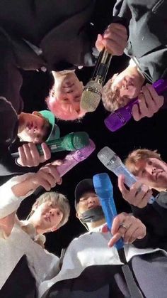 a group of people holding toothbrushes in their hands