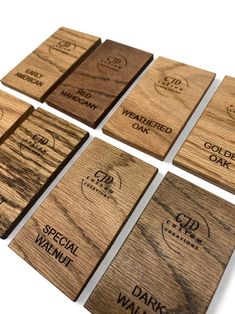 six wooden coasters with different types of logos on them, all made out of wood