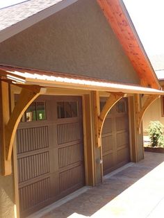 a house with two garage doors and an attached porch