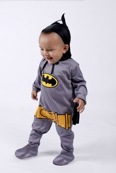 a baby dressed up in a batman costume