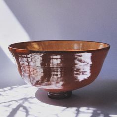 a brown bowl sitting on top of a table