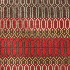 a close up view of a red and brown rug