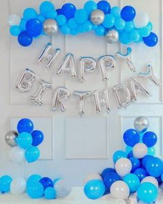 balloons and streamers are arranged in the shape of an arch for a happy birthday