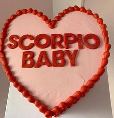 a cake shaped like a heart with the words scorpio baby written on it