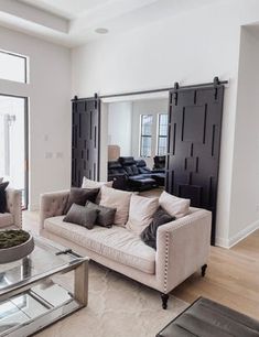 a living room filled with furniture and windows