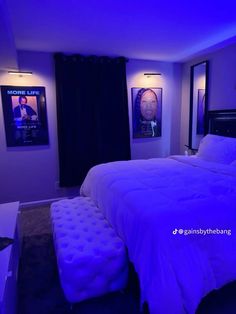 a bedroom with purple lighting and pictures on the wall above the bed, along with a footstool