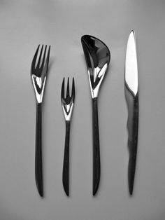 four forks, two knives and three spoons on a gray surface with black handles