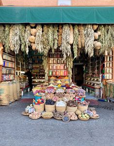 an outdoor market with lots of baskets and food items on display in front of it