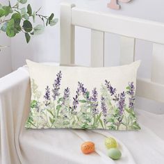 a pillow with lavender flowers on it next to eggs