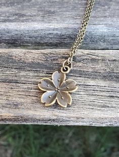 "This cute Sakura flower (cherry blossom) necklace would make a great gift! The flower and chain are an antique bronze color and measures 3/4\". You can choose the length of your necklace at checkout. This would make a great gift for a bridesmaid or a birthday, an anniversary or Christmas. All jewelry items come in a gift box." Bronze Flower-shaped Jewelry Gift, Antique Necklace With Flower Charm As Gift, Flower Shaped Necklace With Vintage Charm For Gift, Flower Shaped Necklace With Vintage Charm As Gift, Vintage Flower Charm Necklace For Gift, Vintage Flower-shaped Nickel-free Necklaces, Cute Sakura Flower, Sakura Necklace, Cute Sakura