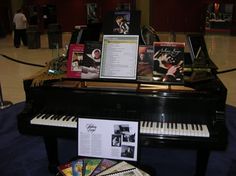 there is a piano and other items on display