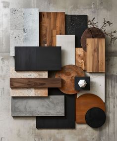 an assortment of wood and metal pieces on display in a room with concrete walls, flooring and cement floors