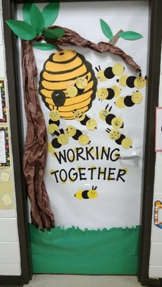 a bulletin board that has been decorated to look like a beehive and the words working together