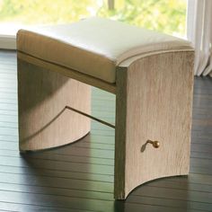 a wooden bench sitting on top of a hard wood floor next to a sliding glass door