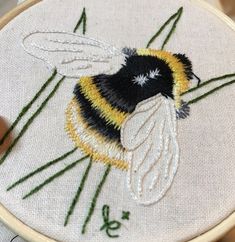 a close up of a small embroidered bee