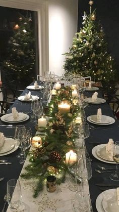 a long table is set with candles and place settings for an elegant christmas dinner party