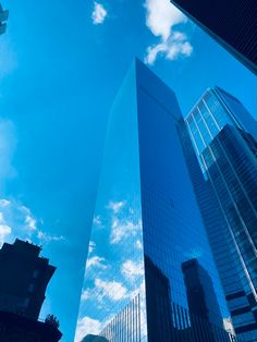 two tall buildings are shown against the blue sky