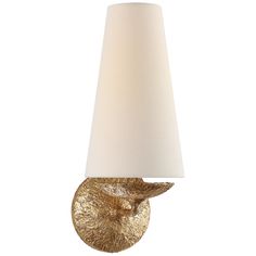 a gold wall light with a white shade