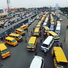 a busy street filled with lots of yellow buses