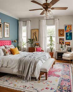 a bedroom with blue walls, pink headboard and white bedding is pictured in this image