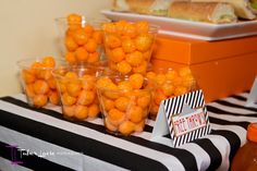 oranges are in small cups on a table